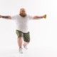 Fat man is lifting dumbbells with efforts. He is standing and stretching arms sideways. Isolated