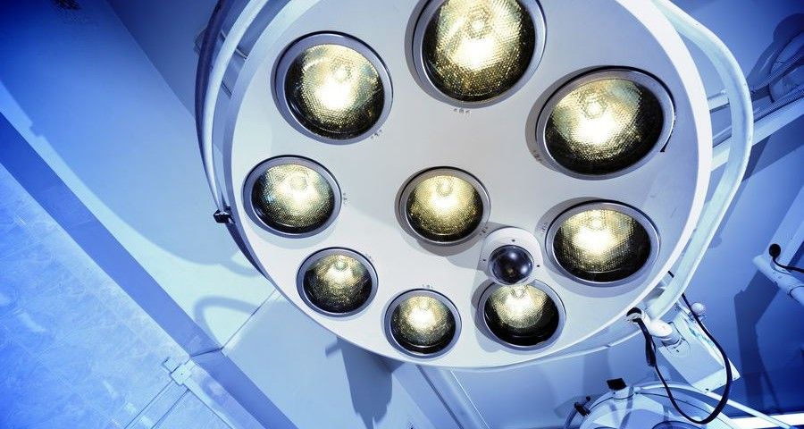 Two surgical lamps in operation room. Blue cast light represent purity and clinical mood. Useful file for your hospital brochure, medical article and other purpose.