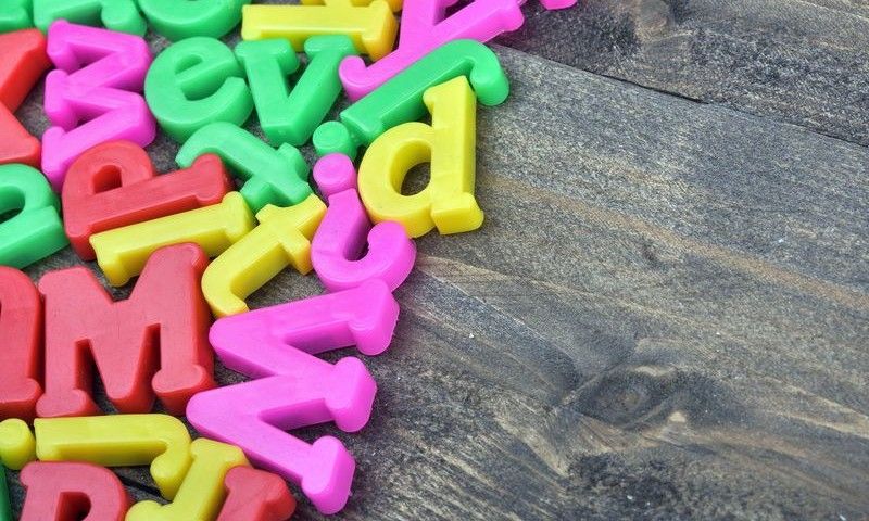 Many letters word on wooden table