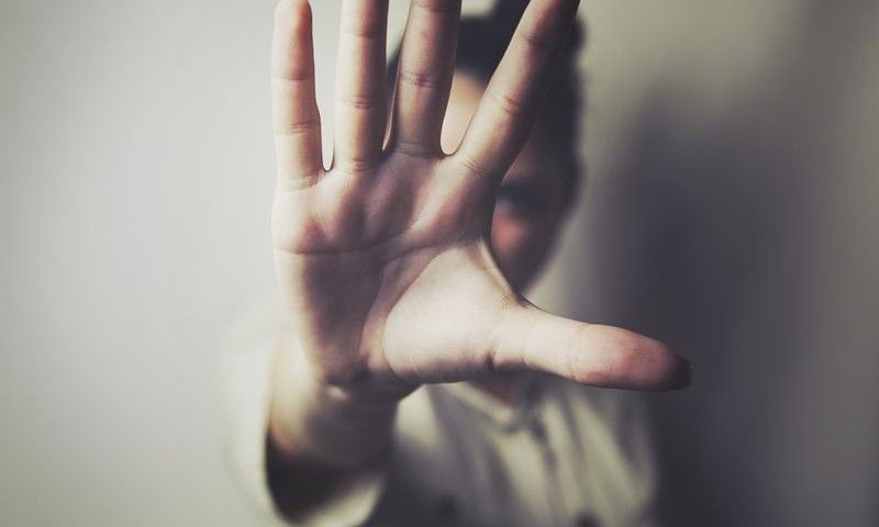 Young woman showing her denial with NO on her hand