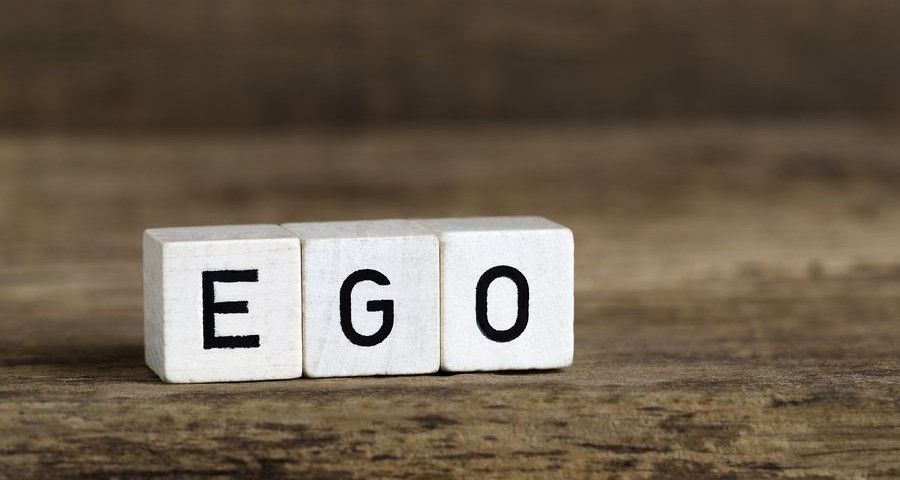 The word ego written in cubes on a wooden background