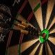 Success hitting target aim goal achievement concept background - three darts in bull's eye close up