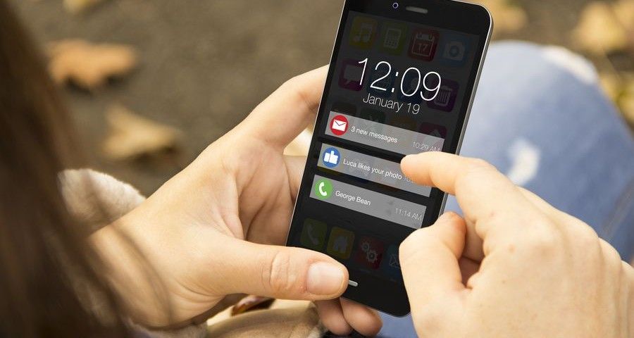 connectivity concept: woman holding a 3d generated smartphone with notifications on the screen. Graphics on screen are made up.