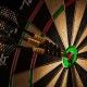 Success hitting target aim goal achievement concept background - three darts in bull's eye close up