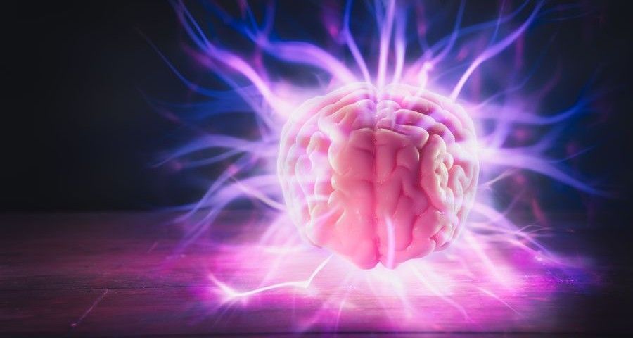 high contrast image, mind power concept with human brain and light rays